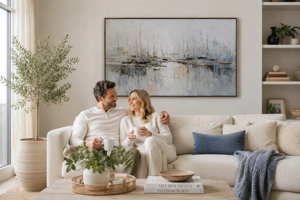 A heavy impasto hand-painted abstract oil painting hanging above a sofa in a minimalist wabi-sabi living room, serving as an elegant housewarming gift.