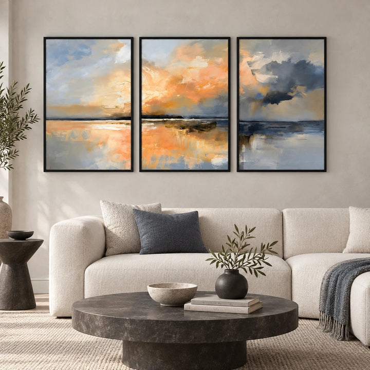 TP1419 coastal landscape triptych in black frames above an ivory sofa in a modern living room